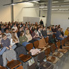 Students sit on chairs and listen eagerly to a lecture.