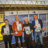 Four trainers stand side by side in Signal Iduna Park, holding a certificate in their hands.