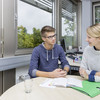 Two persons sitting at a desk