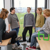 Group picture of students in a seminar room with the TU Dortmund logo.