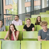 A group of students are sitting in a lecture hall.